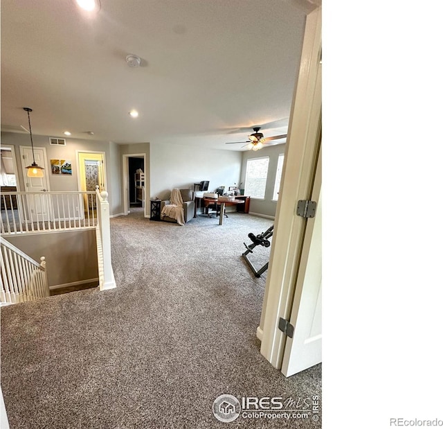 living room with ceiling fan and carpet flooring