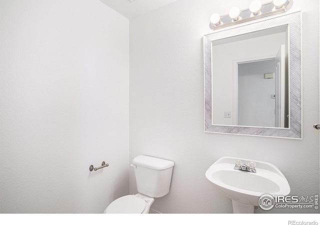 bathroom featuring sink and toilet