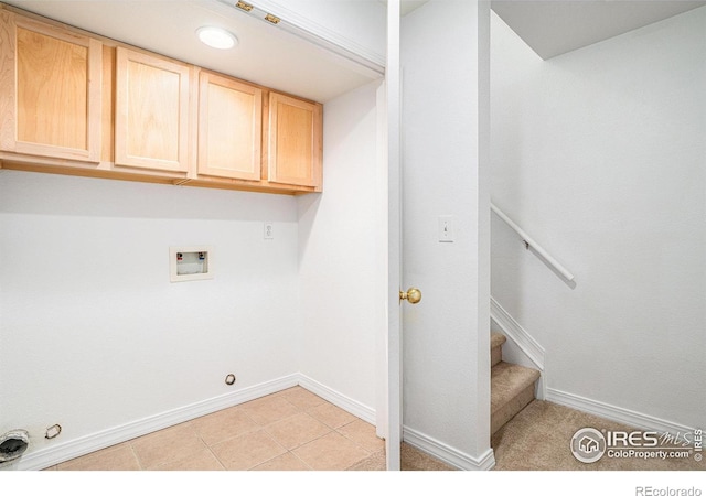 washroom featuring cabinets, washer hookup, gas dryer hookup, and light tile patterned floors