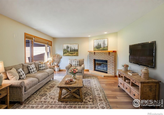 living room with hardwood / wood-style flooring and a fireplace