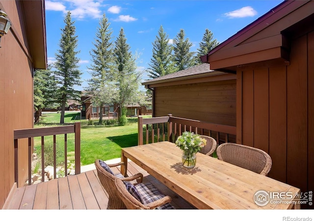 wooden deck with a lawn