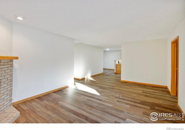 unfurnished living room with wood-type flooring