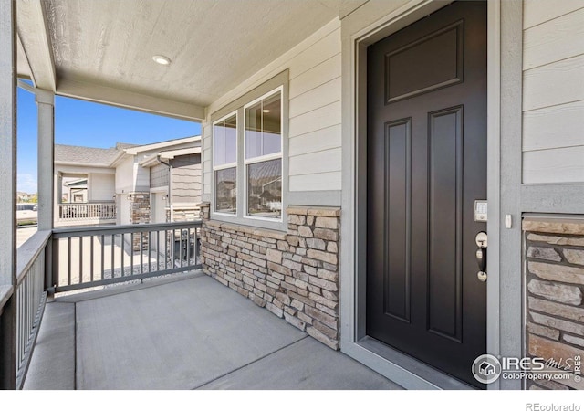 view of exterior entry with covered porch