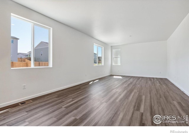 spare room featuring wood-type flooring