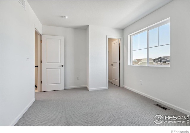 unfurnished bedroom with light colored carpet