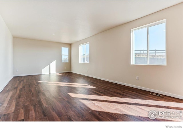 spare room featuring dark wood-type flooring