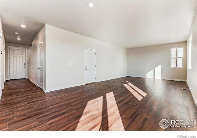 empty room featuring dark hardwood / wood-style flooring