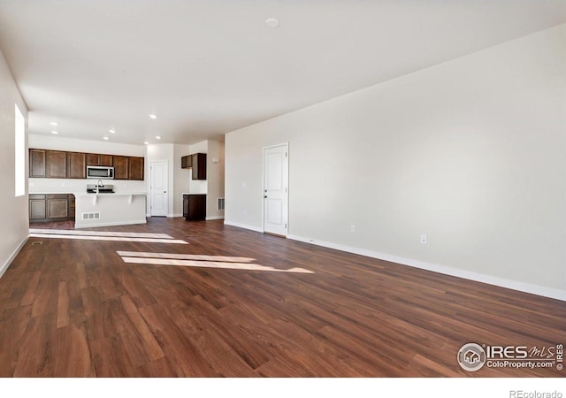 unfurnished living room with dark hardwood / wood-style floors