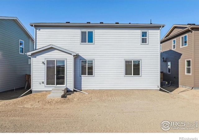 rear view of house with central AC