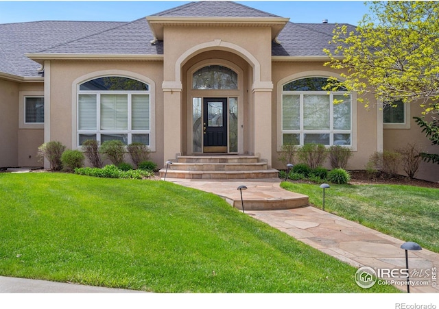 doorway to property featuring a yard