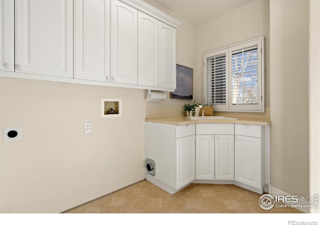 washroom with hookup for an electric dryer, cabinets, sink, and hookup for a washing machine