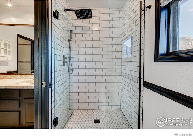 bathroom featuring vanity and a shower with shower door