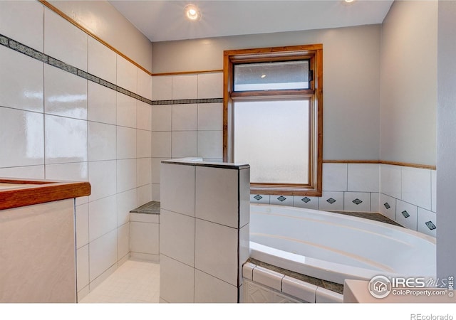 bathroom featuring tiled tub