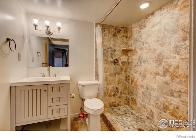 bathroom featuring vanity, toilet, and walk in shower