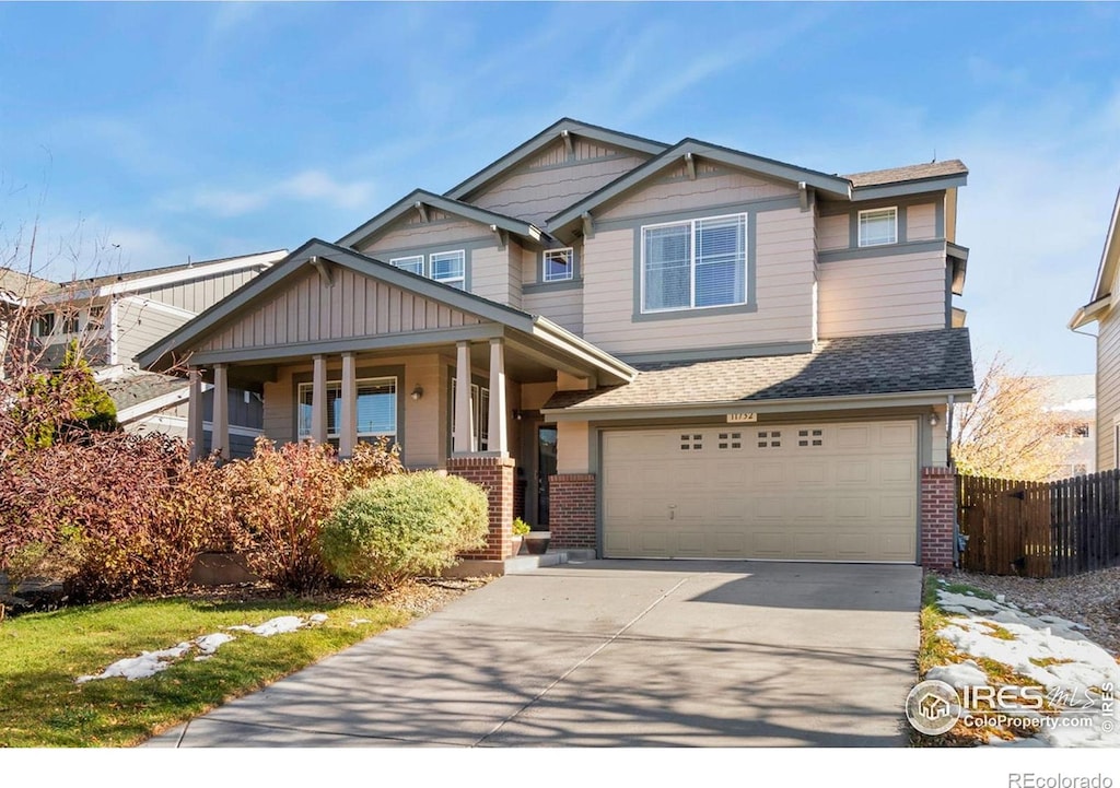 craftsman inspired home featuring covered porch and a garage