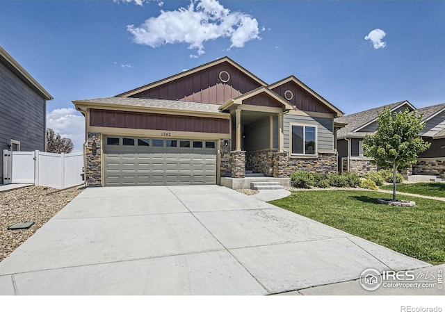 view of front of property with a front lawn and a garage