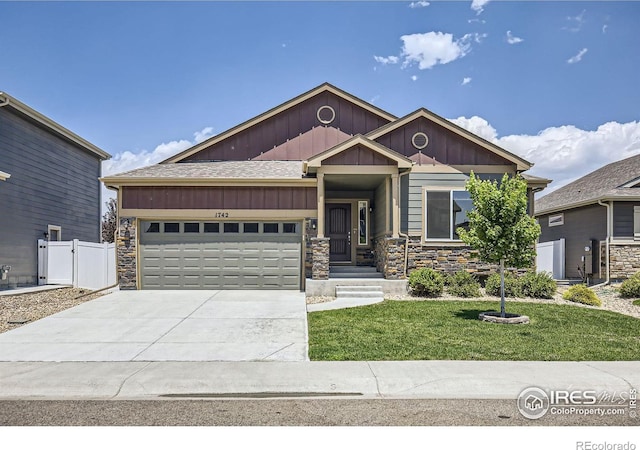 craftsman-style home with a front lawn and a garage