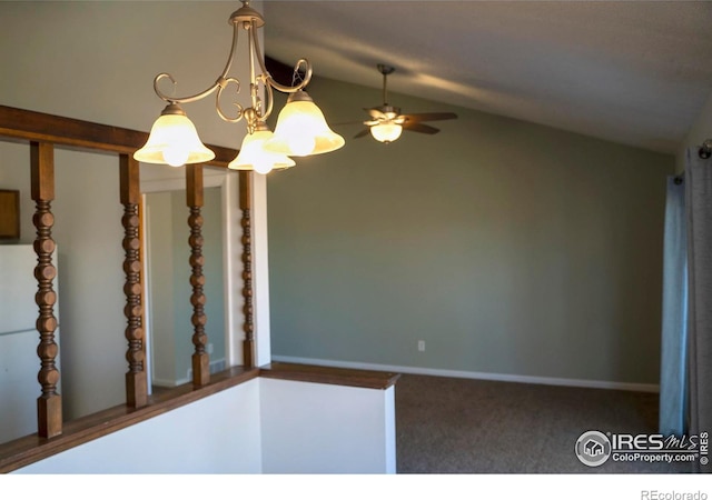 carpeted spare room featuring ceiling fan with notable chandelier and lofted ceiling