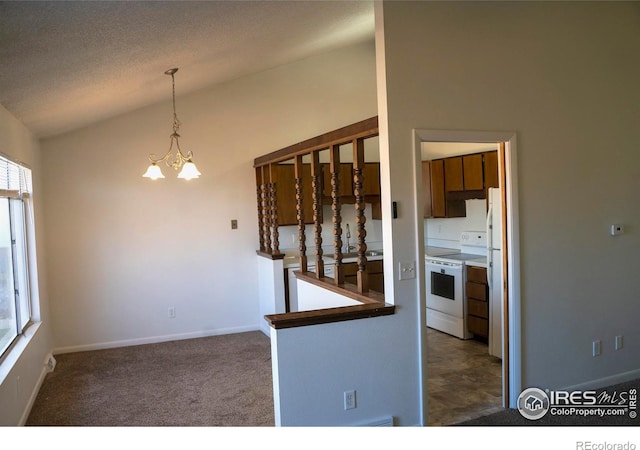 interior space with a notable chandelier, a textured ceiling, lofted ceiling, white appliances, and dark carpet