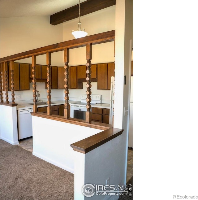 kitchen featuring sink, lofted ceiling with beams, decorative light fixtures, white appliances, and carpet