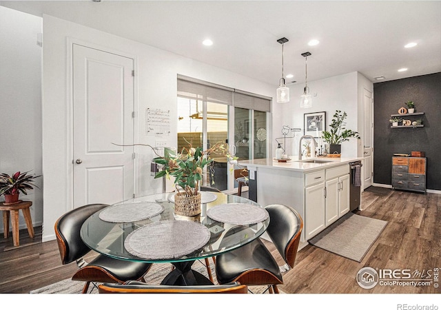 dining room with sink and dark hardwood / wood-style flooring