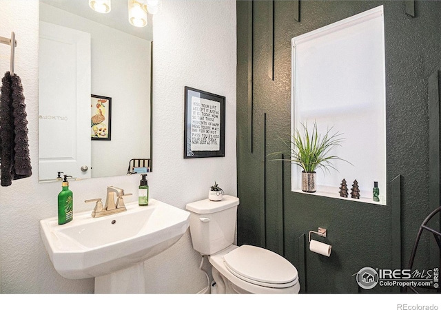 bathroom with toilet and sink