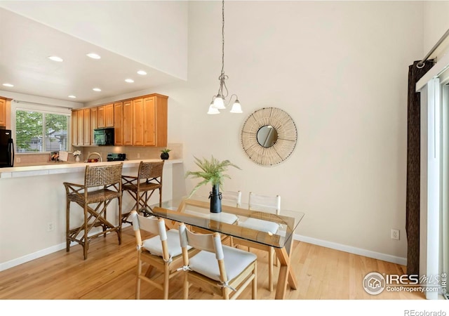 dining room with a chandelier and light hardwood / wood-style floors