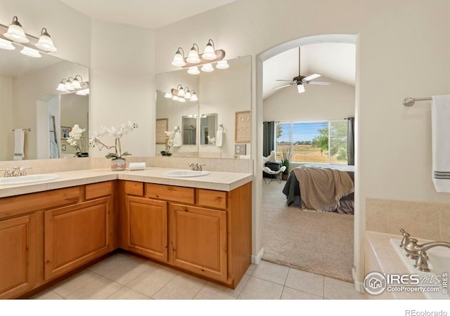 bathroom featuring tile patterned flooring, ceiling fan, vanity, and vaulted ceiling