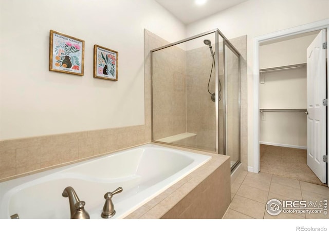 bathroom with shower with separate bathtub and tile patterned floors