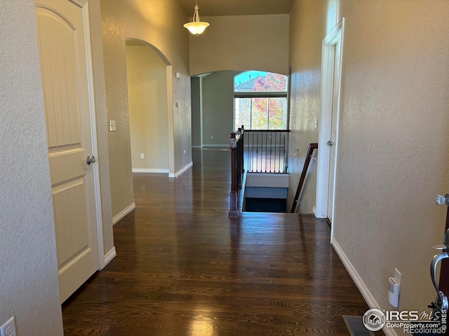 hallway with dark hardwood / wood-style floors