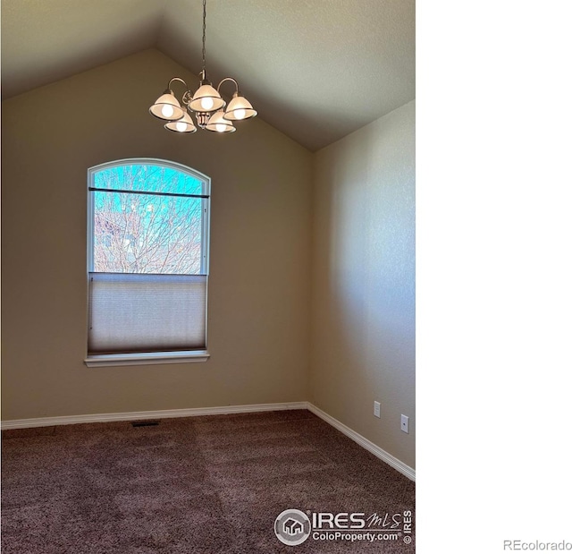 carpeted empty room with a chandelier and lofted ceiling