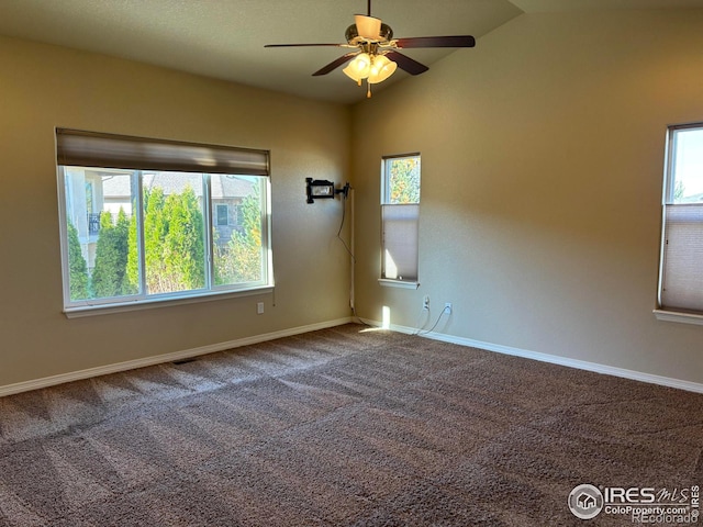 carpeted spare room featuring ceiling fan and lofted ceiling