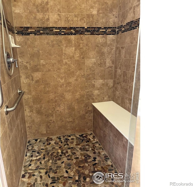 bathroom with a tile shower