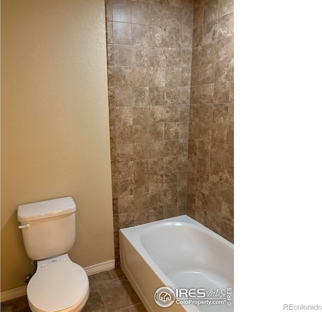 bathroom featuring tile patterned flooring and toilet