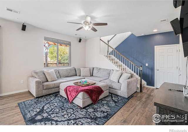 living room featuring hardwood / wood-style floors and ceiling fan