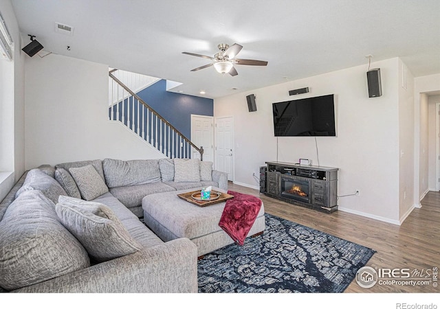 living room featuring ceiling fan and wood-type flooring