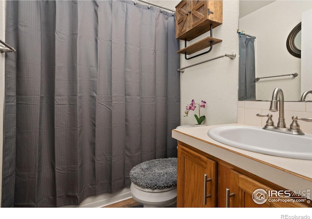 bathroom featuring vanity and toilet