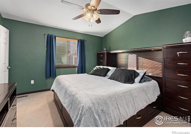 carpeted bedroom featuring ceiling fan and vaulted ceiling