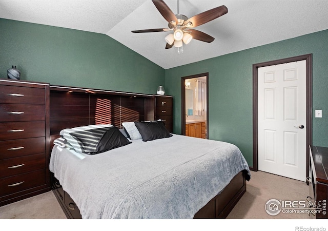 carpeted bedroom featuring ceiling fan, lofted ceiling, and connected bathroom