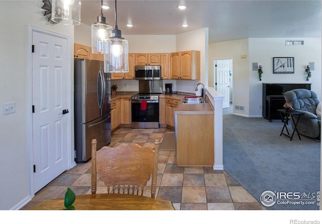 kitchen featuring sink, hanging light fixtures, light carpet, light brown cabinetry, and appliances with stainless steel finishes