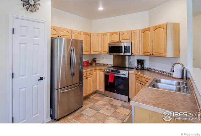 kitchen featuring light brown cabinets, sink, and appliances with stainless steel finishes