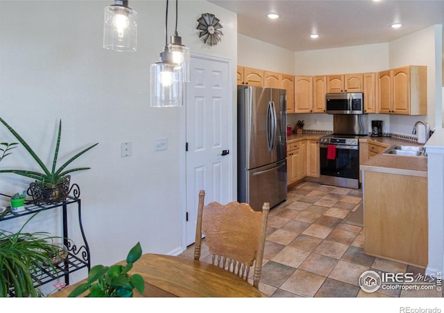 kitchen with decorative light fixtures, stainless steel appliances, light brown cabinetry, and sink