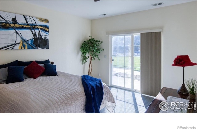 bedroom featuring hardwood / wood-style flooring and access to outside