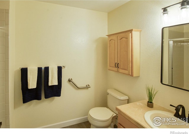 bathroom with vanity, toilet, and walk in shower