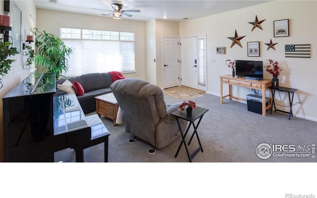 carpeted living room with ceiling fan