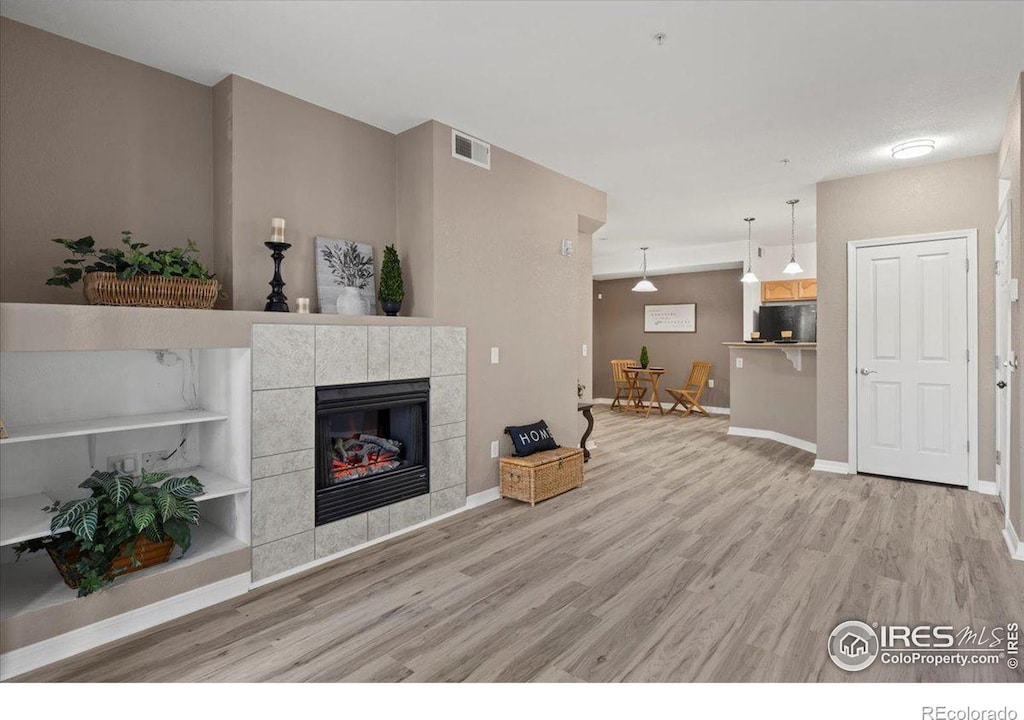 unfurnished living room with a fireplace and hardwood / wood-style floors