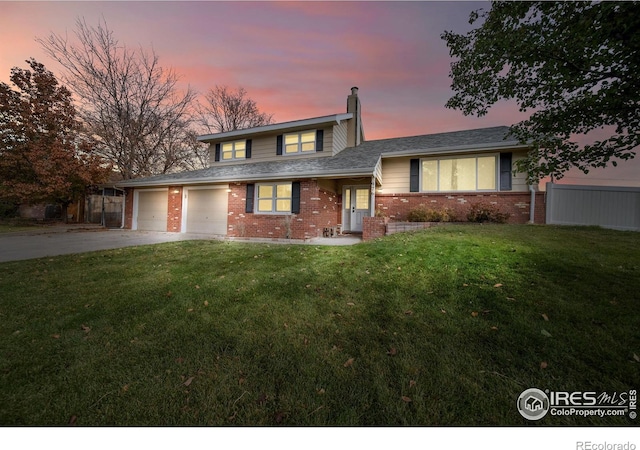 view of front of house featuring a lawn and a garage