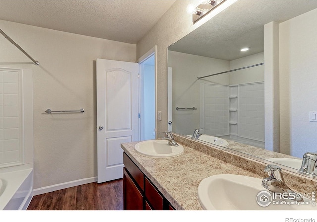 bathroom featuring vanity, hardwood / wood-style floors, and a textured ceiling