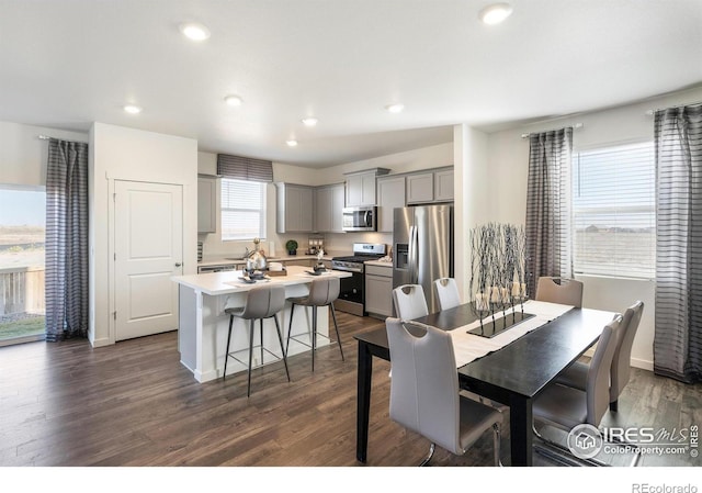 dining area featuring dark wood-type flooring