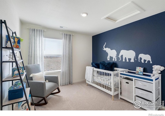 bedroom featuring light carpet and a nursery area